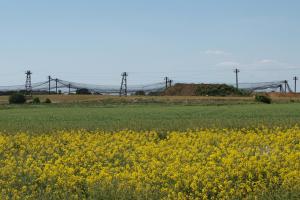 Looking over a field to a large garbage area